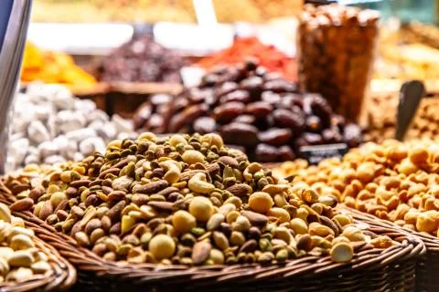 Different nuts: almonds, pistachios, hazelnuts, are on the counter on the mar Stock Photos