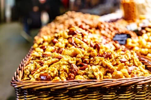 Different nuts: almonds, pistachios, hazelnuts, are on the counter on the mar Stock Photos