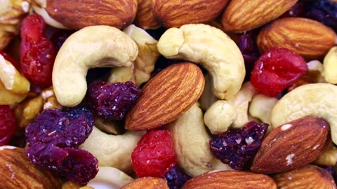 Different nuts and dried fruits mix circle rotation close up top view 스톡 동영상 246848892