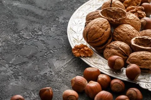 Different nuts on dark stone table. hazelnut,  walnuts Stock Photos
