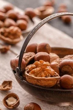 Different nuts on dark stone table. hazelnut,  walnuts. Stock Photos