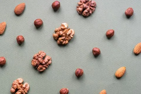 Different Nuts flat lay on textured background Stock Photos