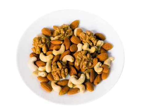 Different nuts lie on a plate. Stock Photos