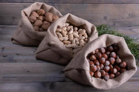 Different nuts in small bags. Stock Photos