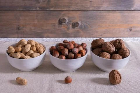 Different nuts stand on the table. Stock Photos