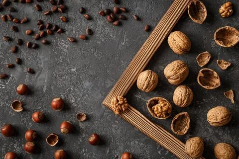 Different nuts on stone table. Cedar, hazelnut, walnuts. Stock Photos
