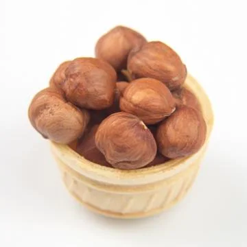 Different nuts in a waffle basket on a white background. Vitamin wholesome fo Stock Photos