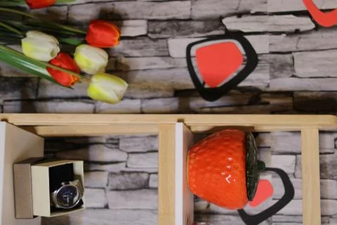 Different objects including a camera red glass box Wristwatch  flowers domino Stock Photos