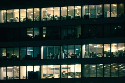 Different office floors reality in the same building at night Stock Photos