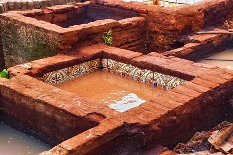 Different old stone vats with red dye for leather at Tannery of Tetouan Med.. Stock Photos