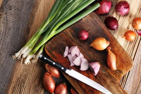 Different onions on wood Stock Photos