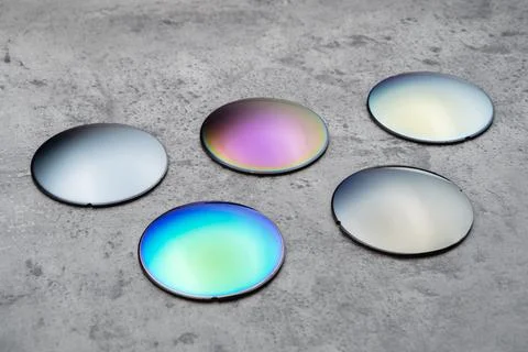 Different optical lenses on table in opical workshop Stock Photos