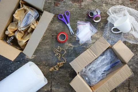 Different packaging for parcels. The concept of protecting fragile goods. Stock Photos