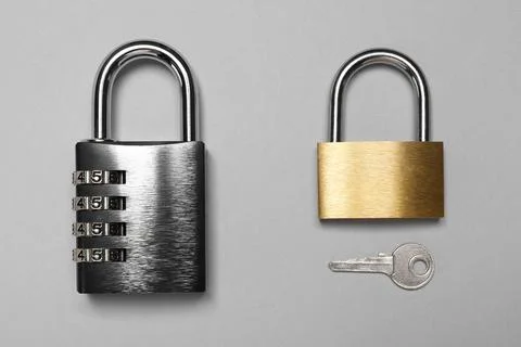 Different padlocks and key on grey background, top view Stock Photos