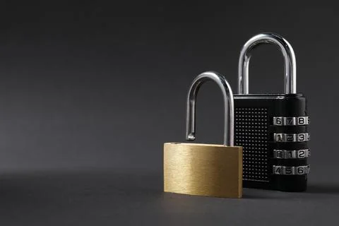 Different padlocks on black background, closeup. Space for text Stock Photos