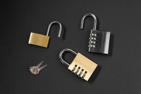 Different padlocks on black background, flat lay Stock Photos