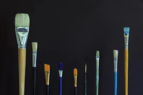 Different paint brushes on dark background. Copy space Stock Photos