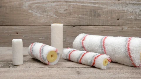 Different paint rollers on wooden background. Panorama. Stockbeeldmateriaal 129974536