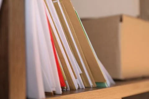 Different paper envelopes and parcel on shelf in post office, closeup 스톡 사진