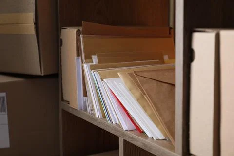 Different paper envelopes and parcels in post office, closeup Stock Photos