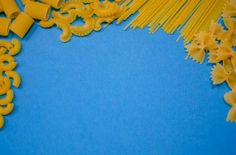Different pasta on a blue background Stock Photos