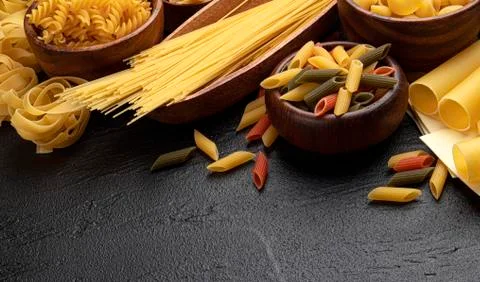 Different pasta types on black background with copy space for text Stock Photos