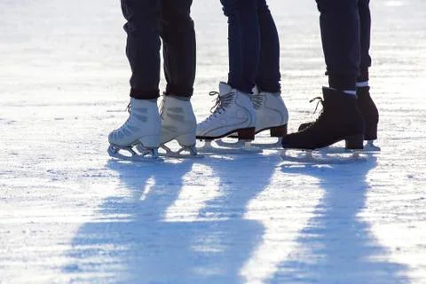 Different people are actively skating on an ice rink Stock Photos