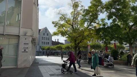 Different people are walking in a small town in Bavaria. Rollator Walker. Stock Footage 221654074