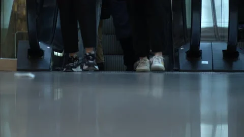 Different people go down the escalator Stock Footage 235579946