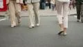 Different people pedestrian walking crossing road day time city HD Footage