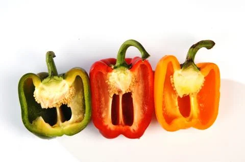 Different peppers on a gray background Stock Photos