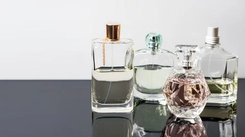Different perfume bottles with reflections. Perfumery, cosmetics. Free space  Stock Photos