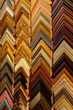 Different picture frames are stacked in a zigzag pattern on display in an art Stock-Fotos