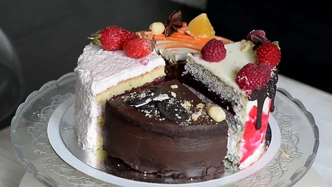The different pieces of the cake smoothly rotate on the base. There is chocolate Stock Footage 76265880