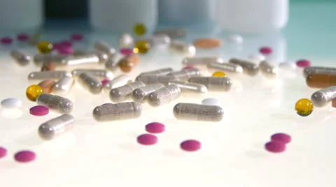 Different pills and cans on white table with camera slides Video stock 65940097