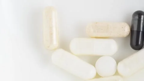 Different pills and vitamins falling on white background. Medical concept, .. Stock Footage 267877402