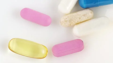 Different pills and vitamins falling on white background. Medical concept, .. Stock Footage 267877407