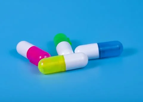 Different pills on blue background Stock Photos