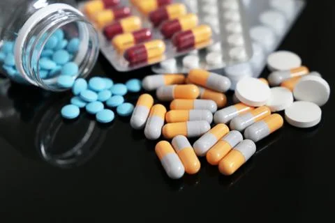 Different pills on a dark glass table Stock Photos