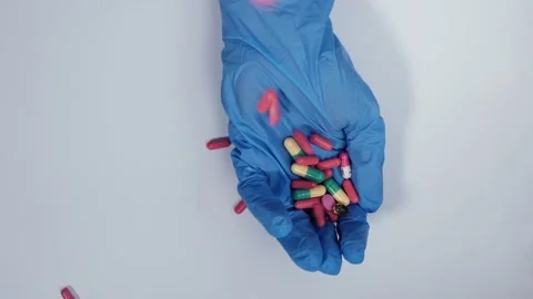 Different pills fall into the doctor's palm, Stock Footage