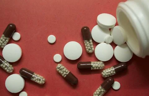 Different pills on a pink background Foto stock