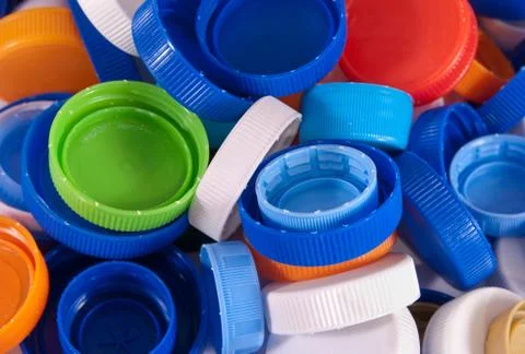 Different plastic bottle caps as a background. Top view Stock Photos