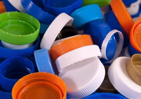 Different plastic bottle caps as a background. Top view Stock Photos