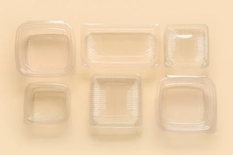 Different plastic containers for food on beige background, top view Stock Photos