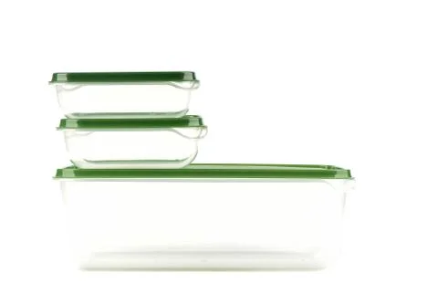 Different plastic containers with a green lid for storing food, isolated on a Stock Photos