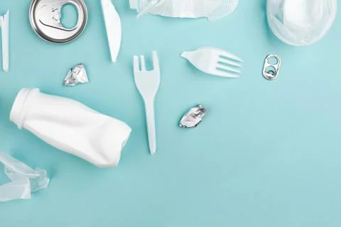 Different plastic garbage on blue background. Plastic waste recycling concept Stock Photos