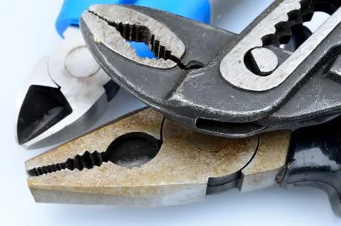 Different pliers on white background Stock Photos