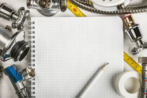 Different plumbing and tools with a notebook Foto stock