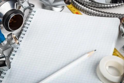 Different plumbing and tools with a notebook Foto stock