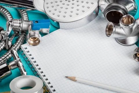 Different plumbing and tools with a notebook Foto stock